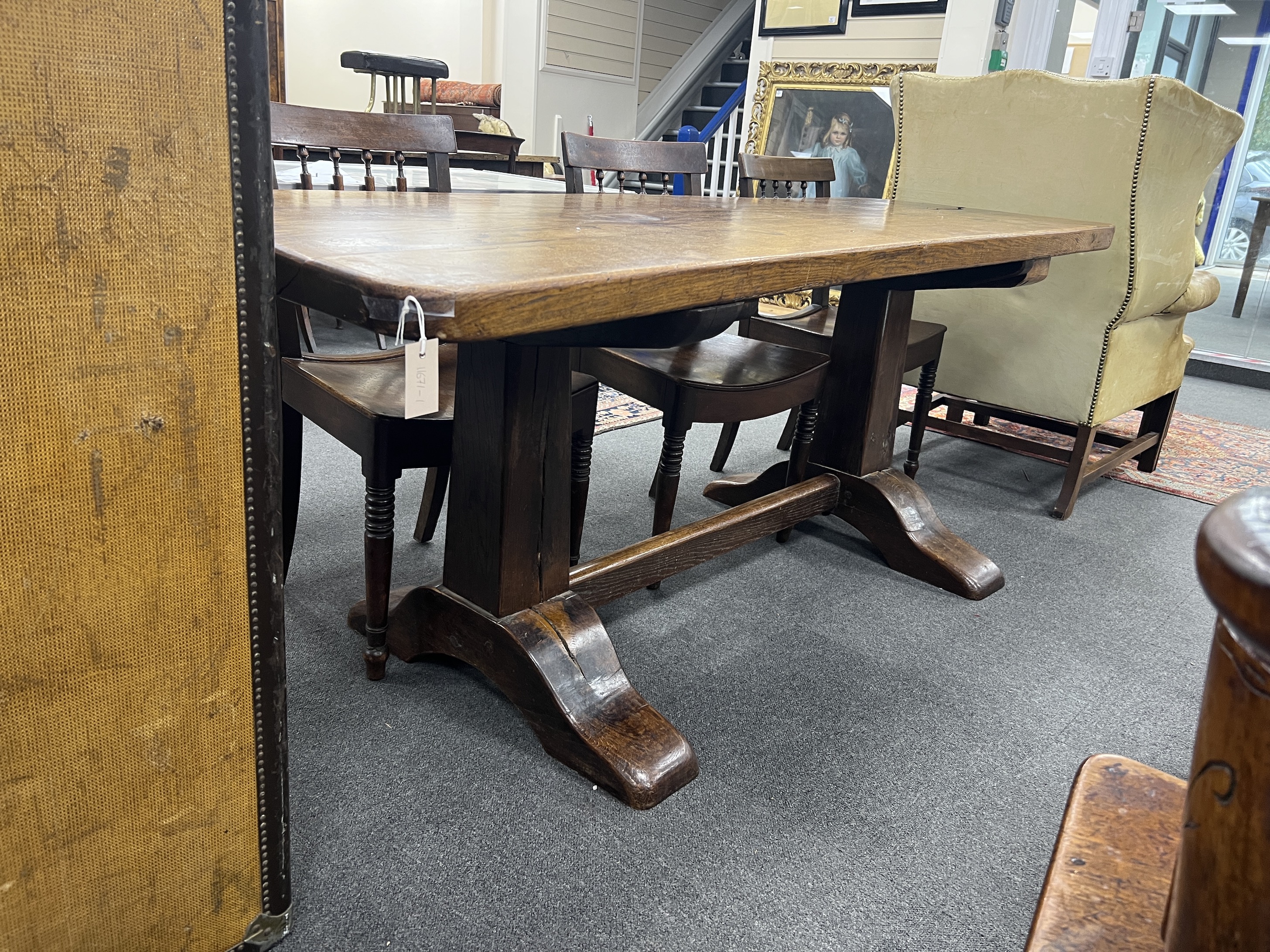 An 18th century style rectangular oak refectory table with single plank top on square end standards, length 194cm, depth 74cm, height 78cm